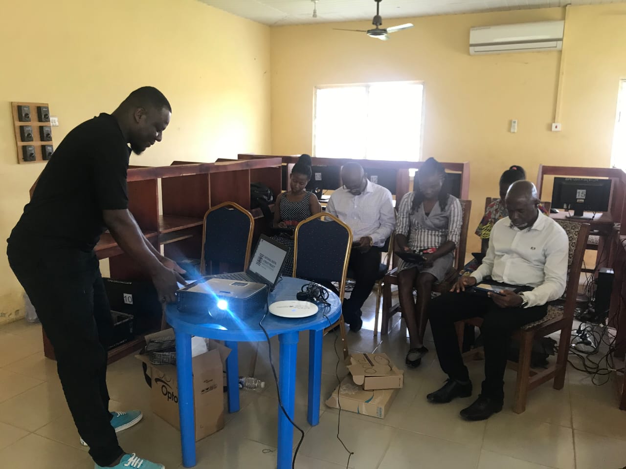 Louis Addor setting up equipment for a digital-inclusion training